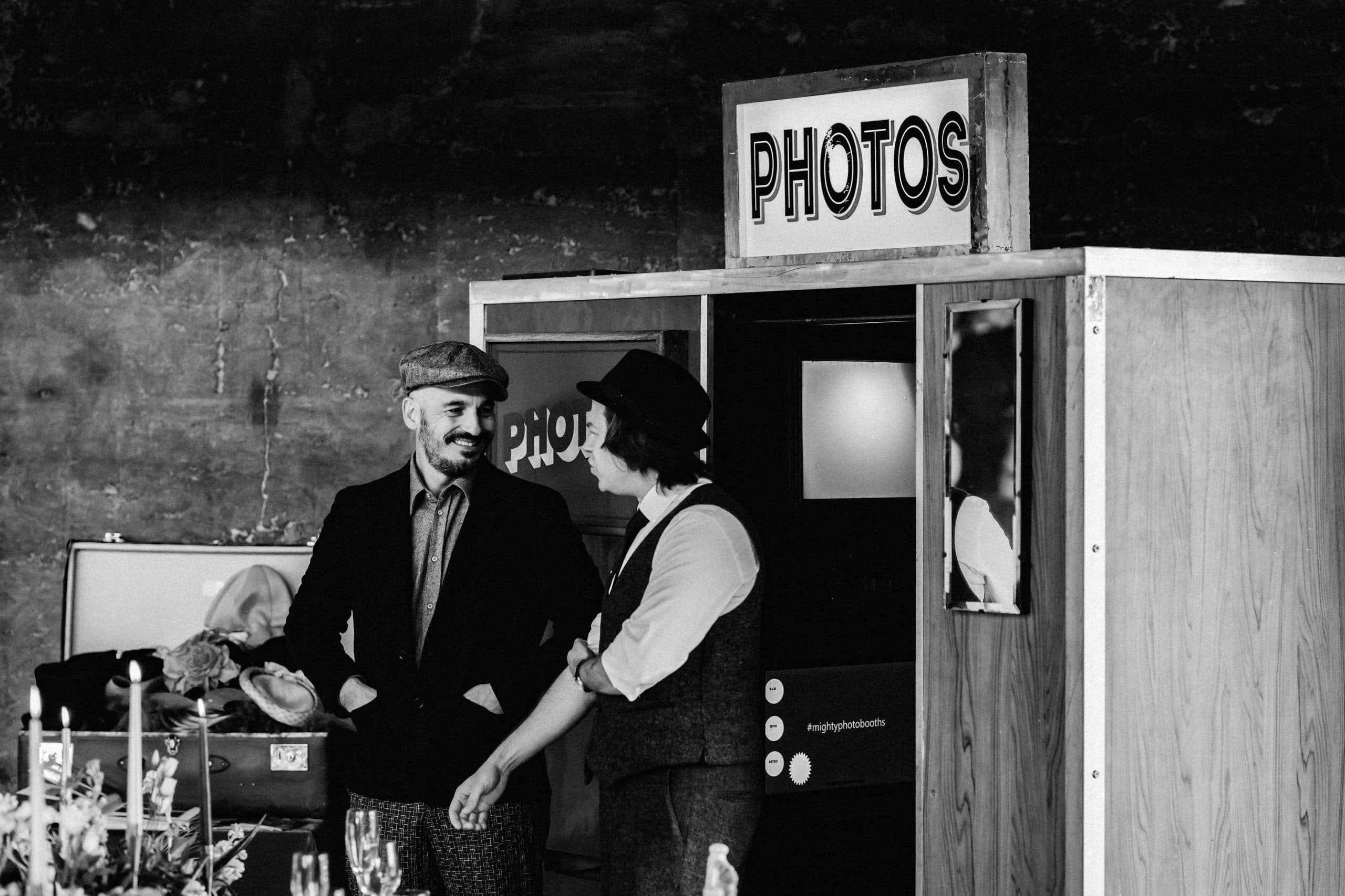 Wedding guests posing with props in a photo booth